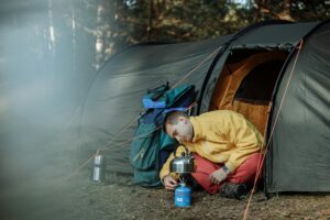 Man lighting a portable camping gas burner
