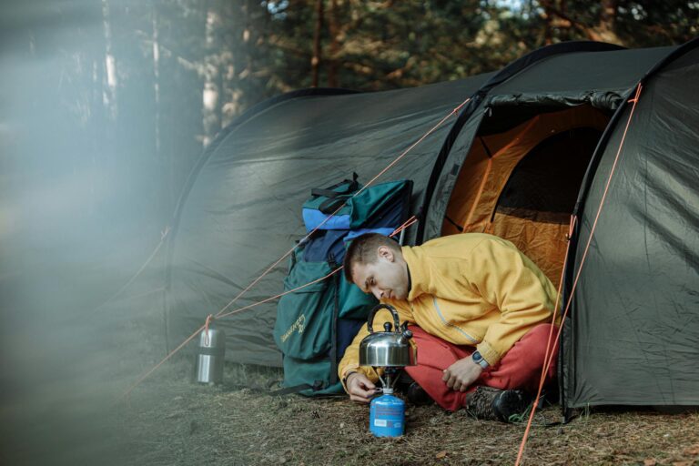 Man lighting a portable camping gas burner